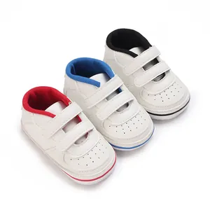 White infant walker sneakers with anti-slip rubber soles in red blue and black accents