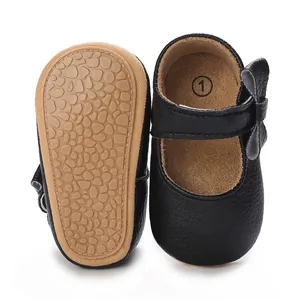 Soft sole black faux leather infant walker shoes with non-slip texture and bow detail