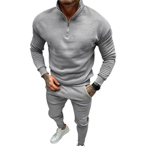 Men's gray tracksuit set featuring half-zip fleece sweatshirt and matching joggers