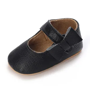 Close-up detail of black leather soft-sole baby walking shoes with velcro strap.