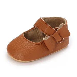 Brown baby walking shoes with soft sole and decorative bow detail.