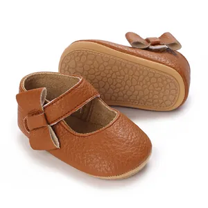 Detail view of brown leather baby walking shoes with soft pebble-textured non-slip sole