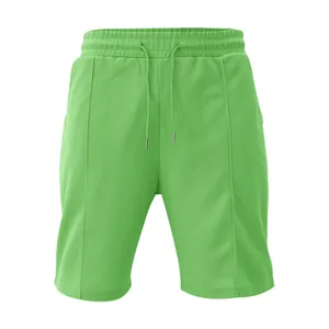 Dettaglio pantaloncini verde chiaro in maglia a nido d'ape con coulisse e cuciture verticali