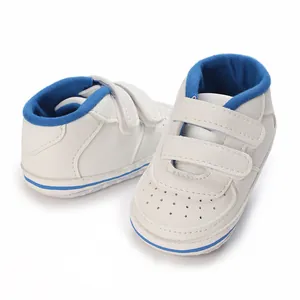 Detail of white and blue baby walking shoes for 0-12 months with anti-slip sole