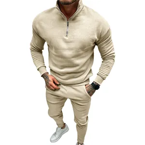 Close-up view of a beige fleece-lined men's tracksuit with a quarter-zip collar detail.
