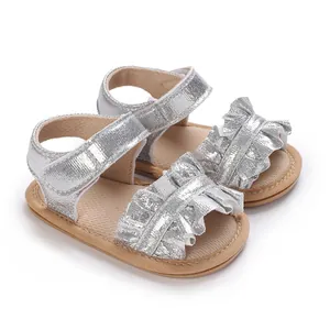 Side view of silver baby girl princess sandals with ruffle detail and soft soles