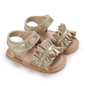 Detailed side view of gold metallic ruffled baby girl pre-walker sandals with velcro strap