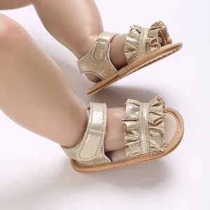 Close-up detail of sparkling golden baby princess sandals featuring elegant ruffle design