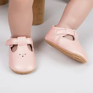 Close-up detail of pink faux leather baby t-strap walker shoes with hook and loop strap