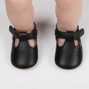 Top view detail of black faux leather baby girl princess shoes with T-strap design
