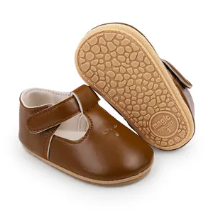 Close-up detail of brown baby prewalker shoes featuring non-slip sole and T-strap design