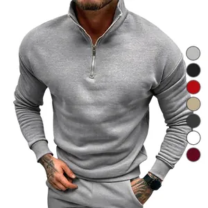 Close-up detail of grey men's quarter-zip sweatshirt with a stand collar and fleece lining
