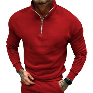 Detailed view of red half-zip fleece sweatshirt with stand collar and ribbed cuffs.