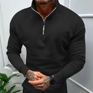Detail view of men's black half-zip sweatshirt showing collar and zipper construction