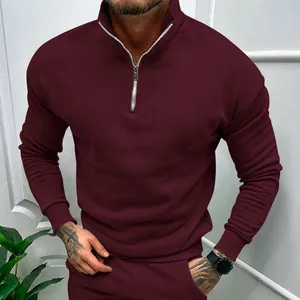 Close-up of men's burgundy half-zip sweatshirt with stand-up collar and ribbed cuffs