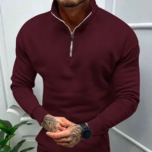 Detail view of men's burgundy sweatshirt featuring half-zip stand collar and fleece fabric