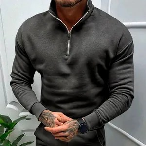 Detail view of men's dark grey quarter-zip fleece sweatshirt with polo stand collar
