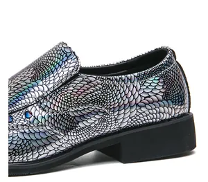 Close-up of holographic dragon scale loafers with iridescent metallic finish and rivets