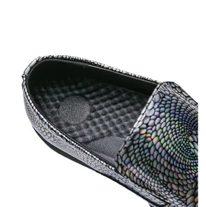 Close-up detail of holographic textured loafer with massaging insole and glossy finish