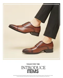 Close-up of elegant brown leather cap-toe derby shoes worn with black trousers.