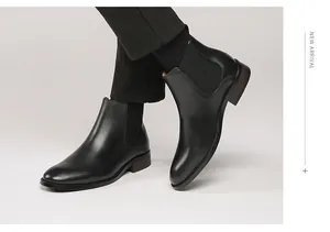 Detailed side view of men's black leather Chelsea boots featuring elastic side panels