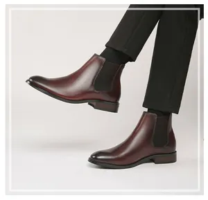 Side view of classic brown leather Chelsea boots for men on a professional model