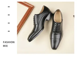 Detailed view of men's black leather cap-toe business dress shoes with lace-up design