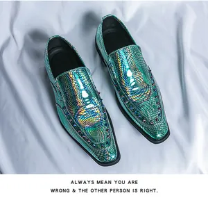 Detailed close-up of iridescent scale texture and metallic spikes on pointed toe loafers