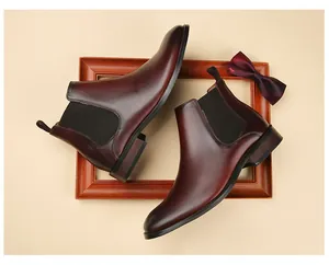 High-quality burgundy leather Chelsea boots with side elastic gore detail.