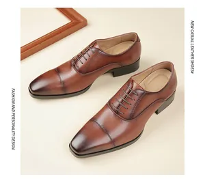 Top-down view of brown leather cap-toe dress shoes for men in formal business style