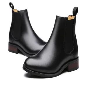 Detailed view of men's genuine leather Chelsea boots in classic black finish