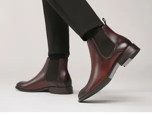 Classic burgundy men's leather Chelsea boots with elegant walking pose presentation