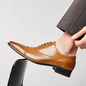 Classic men's tan leather cap-toe Oxford shoes for business suits and formal events