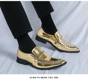 Gold shiny patent leather loafers featuring colorful metallic studs and pointed toe design.