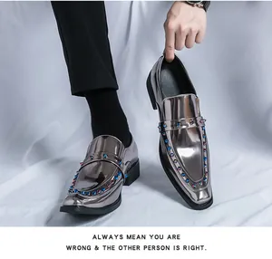 Close-up of metallic silver loafers with colorful blue and red rivets and glossy finish