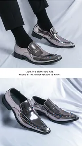 Detail view of silver metallic pointed-toe loafers with colorful studs and patent leather finish.