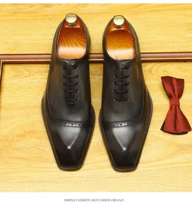 Overhead view of brown handmade leather brogue oxford shoes with decorative carving