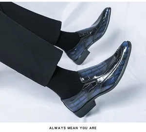 Luxury blue crocodile-embossed patent leather loafers with gradient pointed toe design.