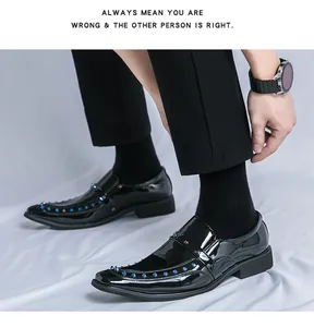 Close-up of black patent leather loafers with colorful studs and pointed toe