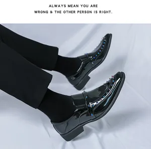 Close-up of trendy black patent leather loafers with vibrant colorful metal spike details