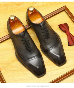 Elegant men's leather brogue oxford shoes featuring intricate carved details and lace-up closure