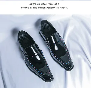 Close-up of black patent leather loafers with colorful rivet details and pointed toe