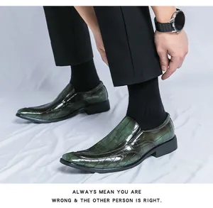 High-quality detail view of men's luxury dark green embossed patent leather loafer shoes.