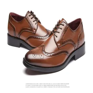 Detail showing the intricate perforated patterns on brown men's wingtip brogue shoes