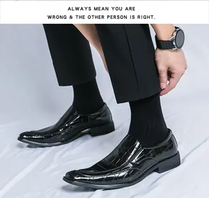 Detail of black glossy embossed pointed-toe loafers for a sleek and modern look