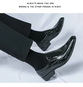 Close-up of glossy black embossed patent leather loafers with a sharp pointed toe.