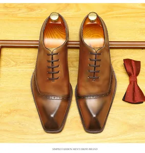 Top-down view of brown leather brogue shoes with elegant decorative perforations