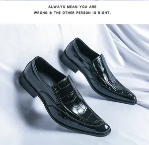 Detailed view of glossy black crocodile-embossed leather loafers with pointed toe