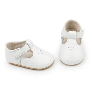 White T-strap baby princess shoes with delicate perforated patterns and velcro strap