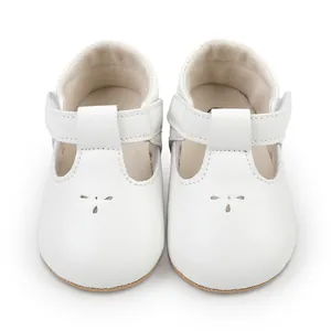 Detailed front view of classic white T-strap baby walking shoes for infants 0-1 year